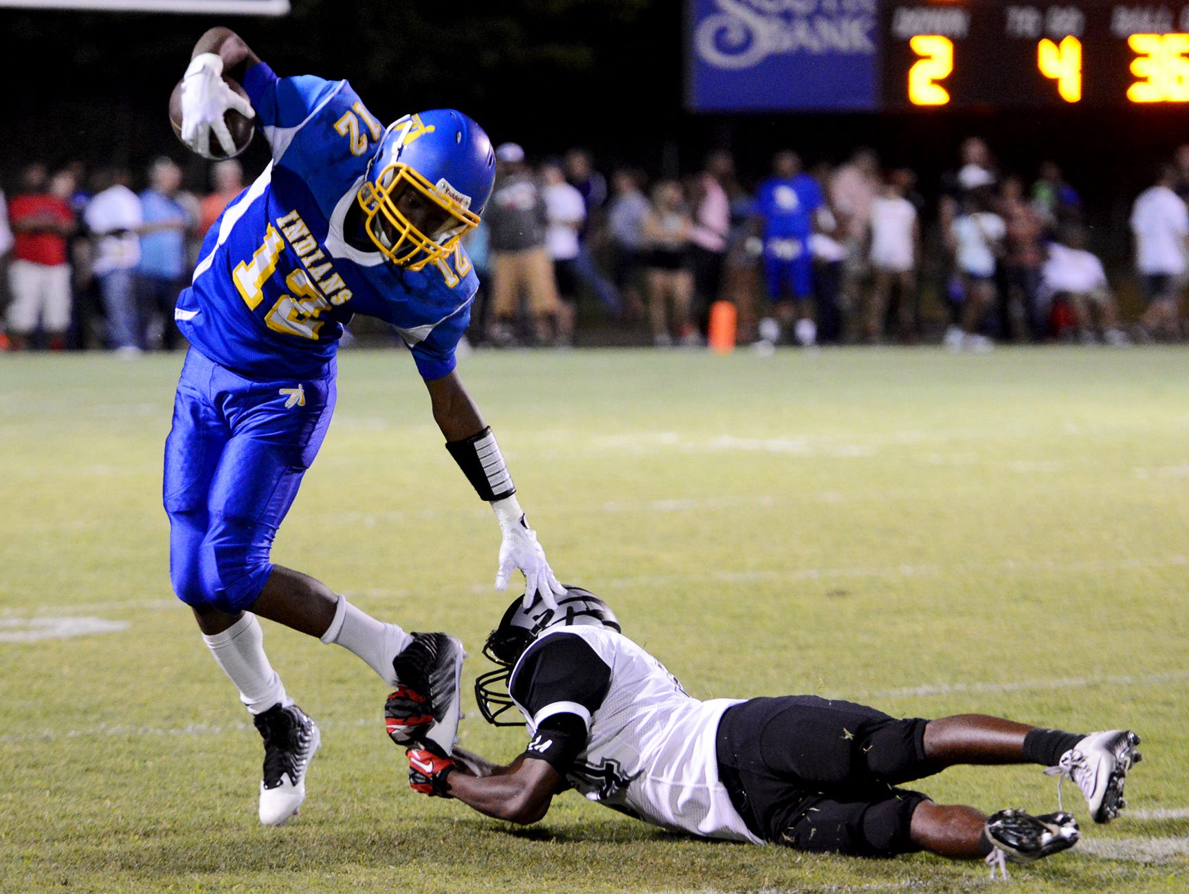 KENNETH CUMMINGS/The Jackson Sun North Side High School's Dexter Pirtle avoids a tackle by South Side?s Shontarrius Word during their game at the 2015 SportsPlus Jamboree, on Friday. North Side High School's Dexter Pirtle avoids a trip by South Sdie's Shontarrius Word during their game at the 2015 Sports PLUS Jamboree, Friday.