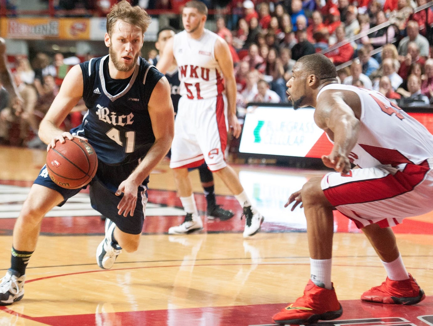 Feb 7, 2015; Bowling Green, KY, USA; Rice Owls forward Seth Gearhart (41) drives the ball away from Western Kentucky Hilltoppers forward George Fant (44) during the second half at E.A. Diddle Arena.