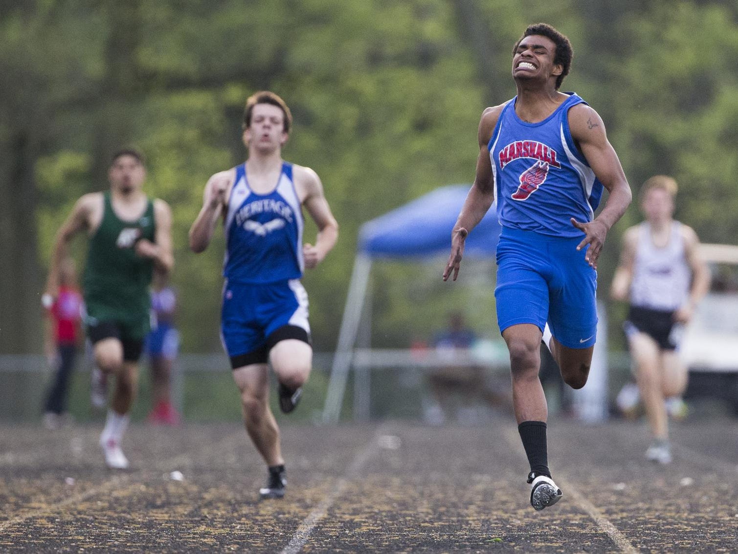 Stoney Prowell (front), a senior at John Marshall, easily wins the boy's 400 meter run, at Arsenal Tech High School, Indianapolis, Friday, May 8, 2015.