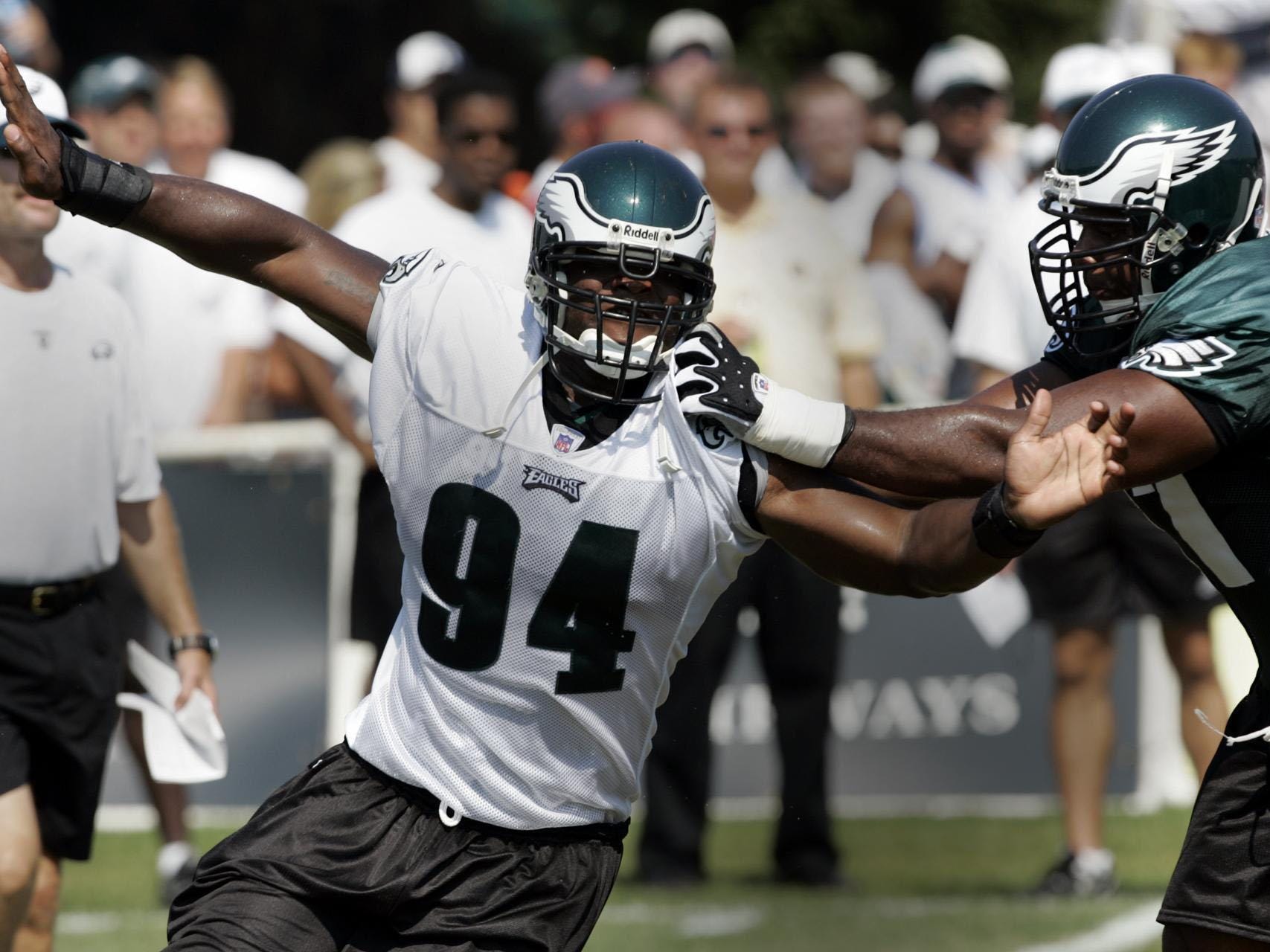 Philadelphia Eagles defensive lineman N.D. Kalu, left, runs by offensive lineman Artis Hicks during the afternoon session of training camp in Bethlehem, Pa., Wednesday, Aug. 3, 2005. (AP Photo/Coke Whitworth)