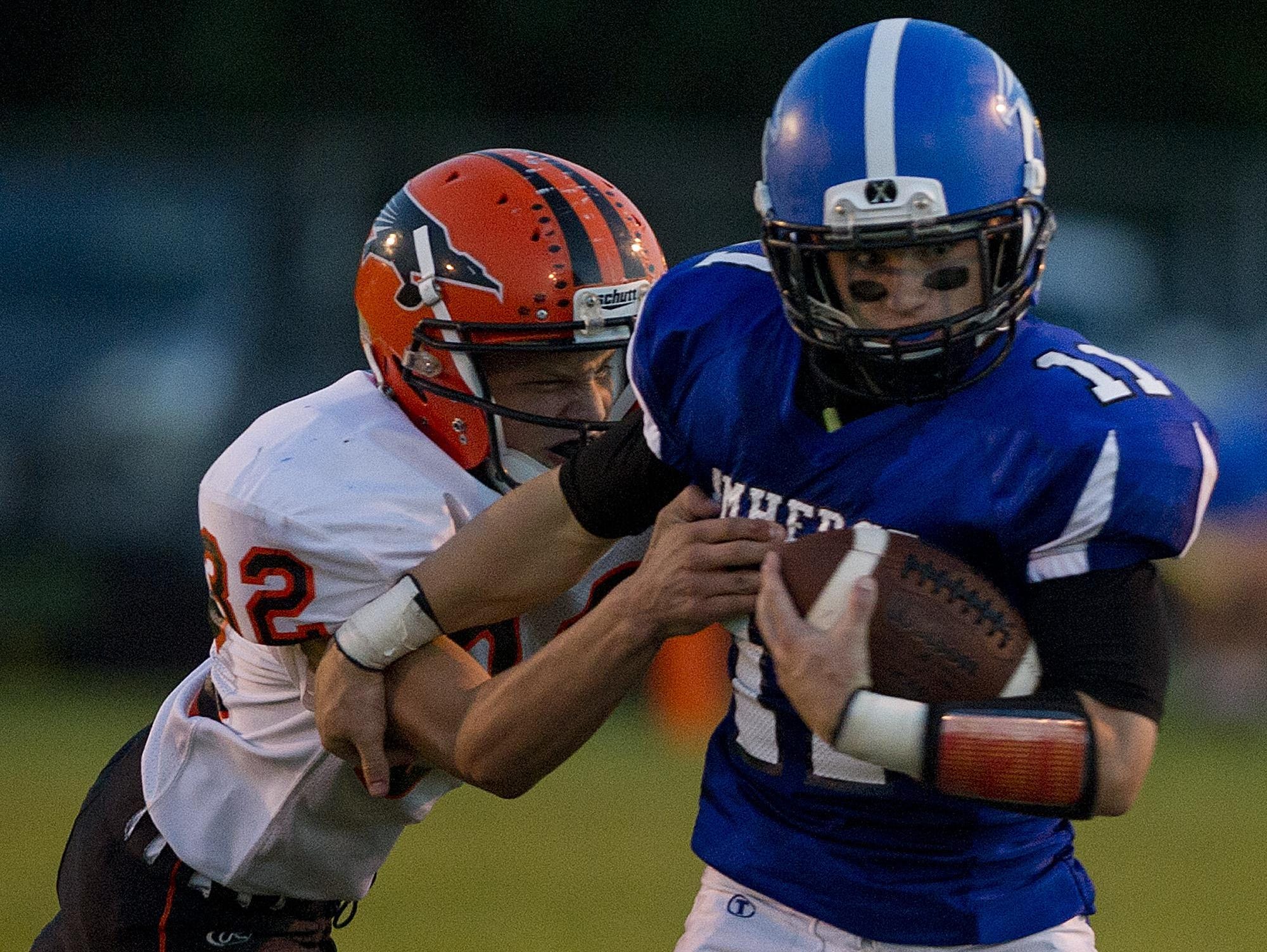 Amherst's Dalton Nemzoff, right, tries to evade Iola-Scandinavia's Jalen Block, left, during their Central Wisconsin Conference game at Amherst High School on Friday, Sept. 4, 2015. Iola-Scandinavia and Amherst are still alive in the prep football playoffs.