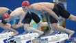 Adam Peaty and Ross Murdoch of Great Britain dive at