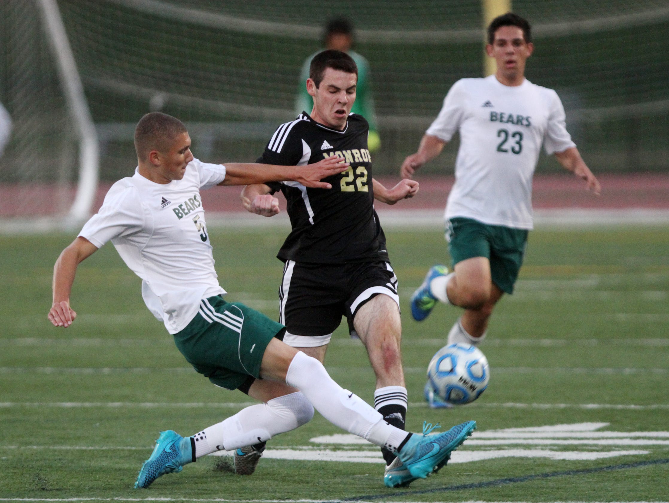 East Brunswick's Zachary Desrosier tackles Monroe's Ryan McCabe during the first half, Thursday, October 8, 2015, in East Brunswick, NJ.