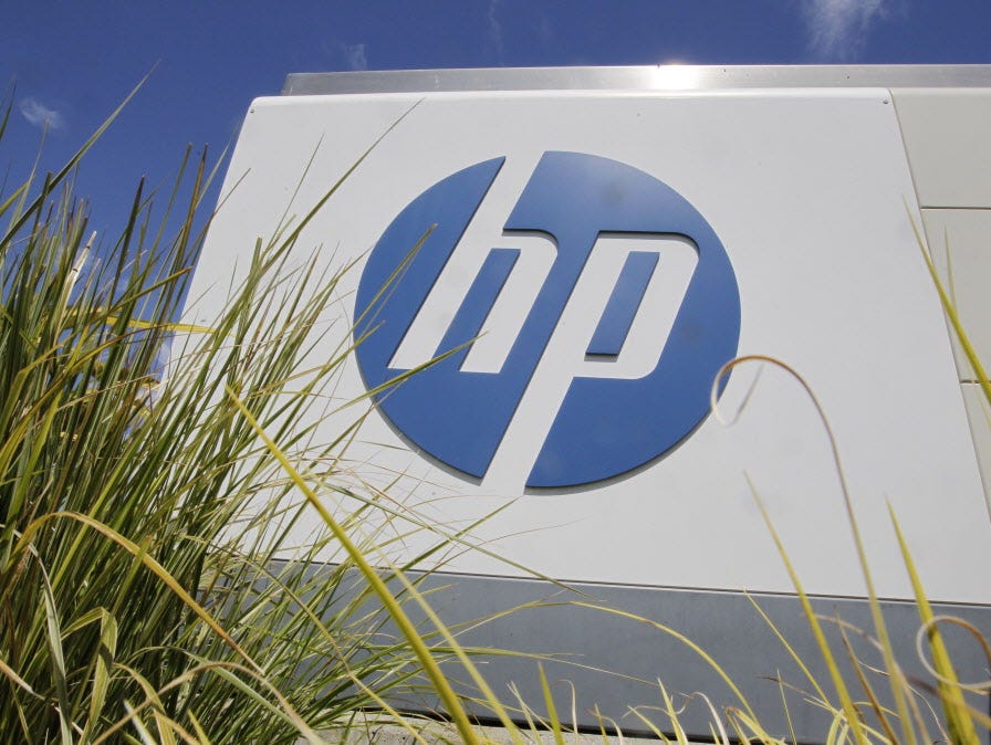 FILE - In this Aug. 21, 2012, file photo, the Hewlett-Packard Co. logo is seen outside the company's headquarters in Palo Alto, Calif. Hewlett-Packard Co. is splitting itself into two companies, one focused on its personal computer and printing busin