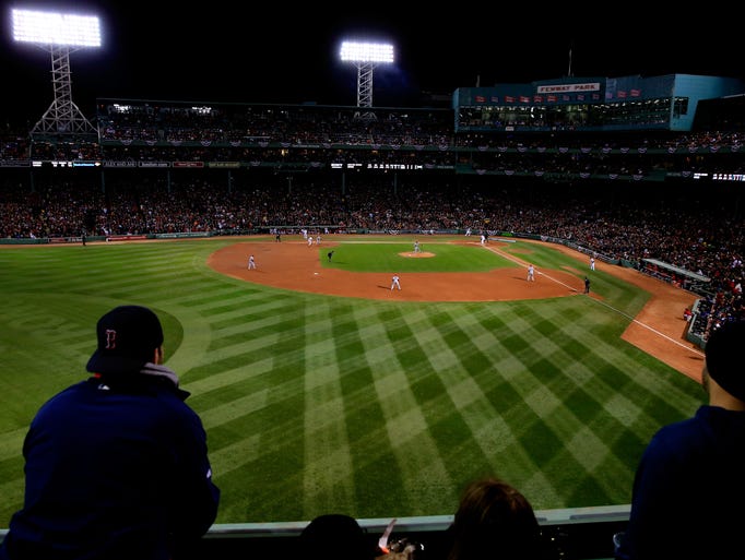 BOSTON, MA - OCTOBER 24: Fans watch from the Green Monster during Game Two of the 2013 World Series between the Boston Red Sox and the St. Louis Cardinals at Fenway Park on October 24, 2013 in Boston, Massachusetts. (Photo by Jamie Squire/Getty Images)