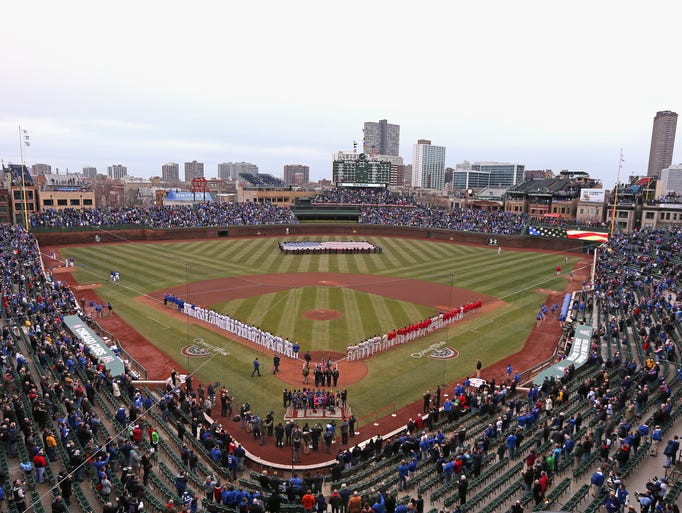 CHICAGO, IL - APRIL 04: Players for the Chicago Cubs and the Philadelphia Phillies stand during the National Anthem before the home opener at Wrigley Field on April 4, 2014 in Chicago, Illinois. (Photo by Jonathan Daniel/Getty Images)