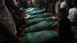 Relatives and friends of the al-Hajj family gather in a mosque, on July 10 to pray over the bodies of eight family members during their funerals in Khan Yunis in the southern Gaza Strip.