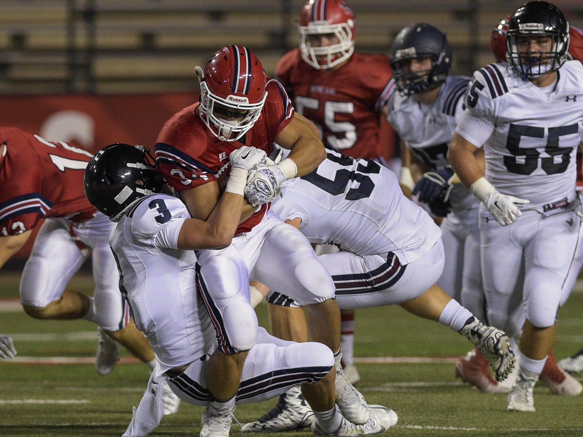 Paul Kieu, The AdvertiserNotre Dame running back Lance Bertrand (34) is tackled by St. Thomas More linebacker Hunter Markerson (3) and defensive end Aaron Monrose (59) during the Kiwanis Jamboree at Cajun Field. Notre Dame running back Lance Bertrand (34) is tackled by St. Thomas More linebacker Hunter Markerson (3) and defensive end Aaron Monrose (59) during the Kiwanis Jamboree at Cajun Field in Lafayette, LA, Thursday, Aug. 27, 2015.