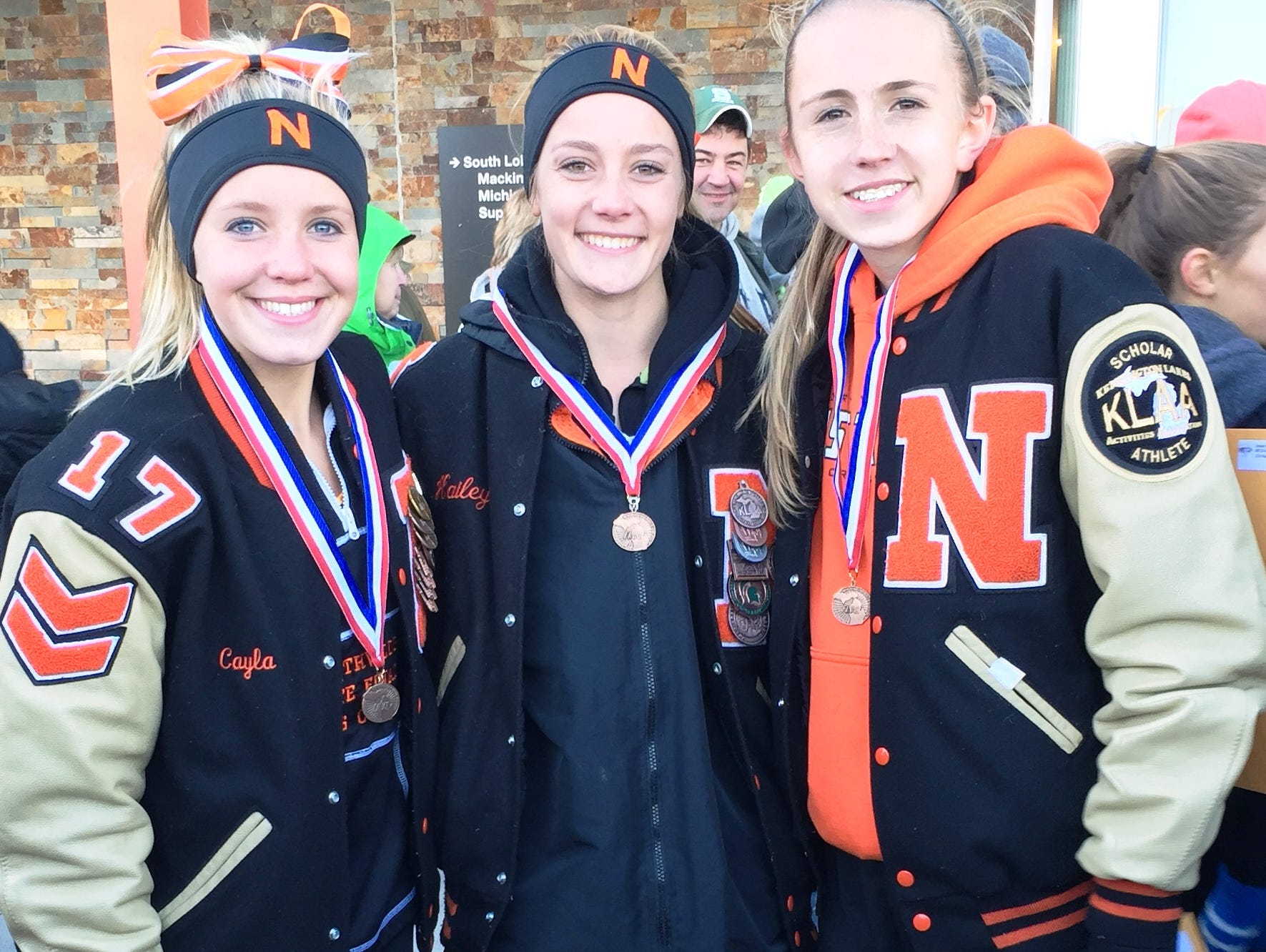 Northville’s Cayla Eckenroth (from left), Hailey Harris and Lexa Barrott earned Division 1 cross country all-state honors Saturday at MIS.