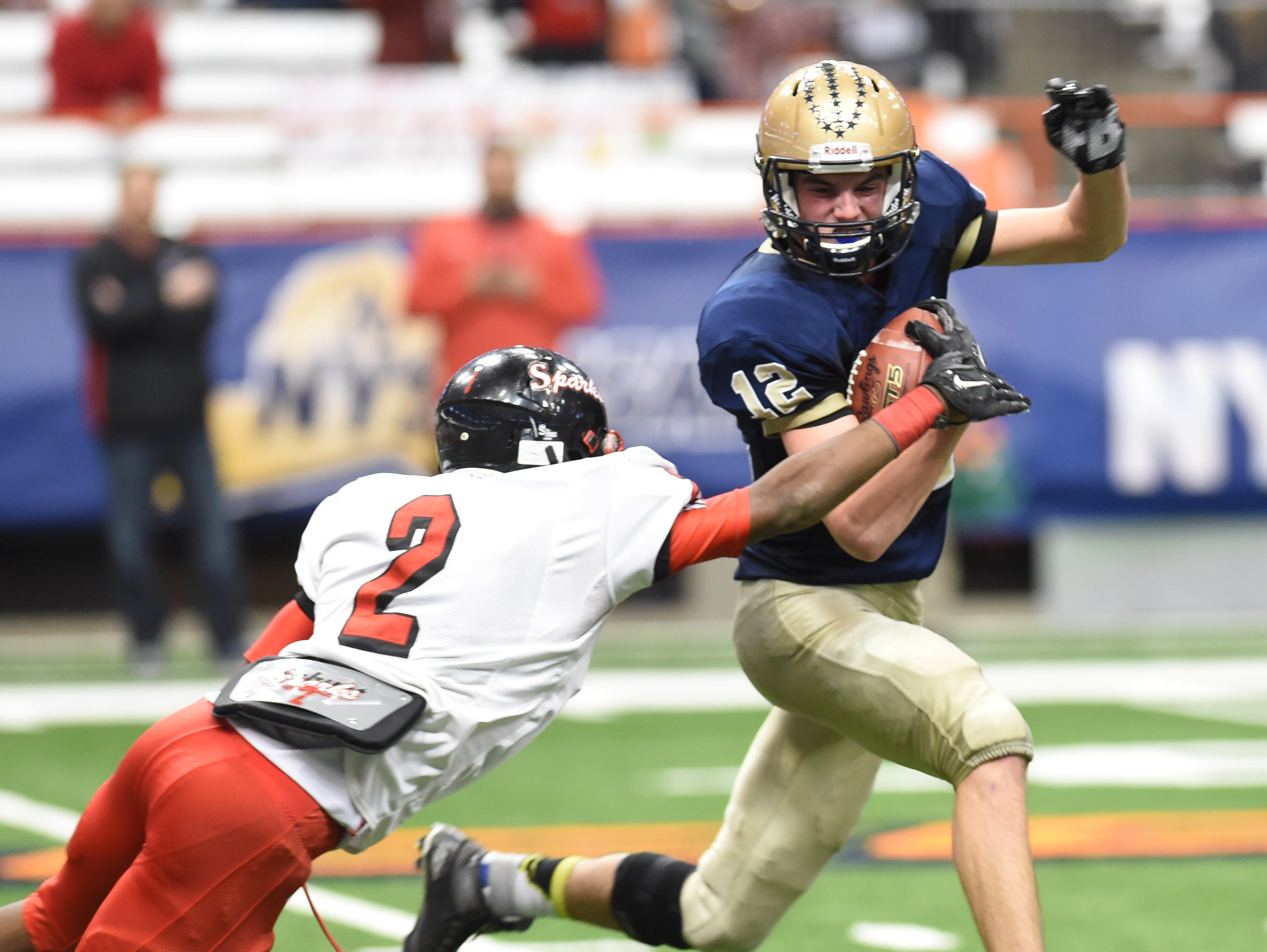 Lourdes' Luke Timm carries the ball away from South Park's Daryl Moore during the New York State Championship final in Syracuse on Friday.