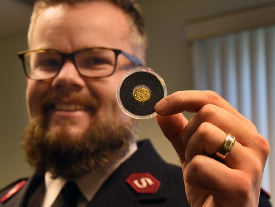 Salvation Army Lt. Jonathan Needham holds a Spanish gold coin Dec. 24, 2016, at the Salvation Army office in Vero Beach, Fla. The coin dates to a 1715 shipwreck off the Florida coast