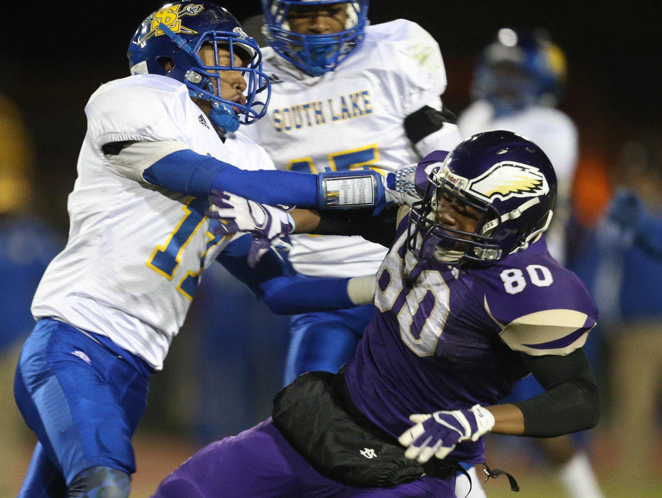 Madison Heights Madison high schools Bacari Marino is hit by South Lake high schools Anthony Morgan during first half action Friday, October 16, 2015 in Madison Heights Michigan.