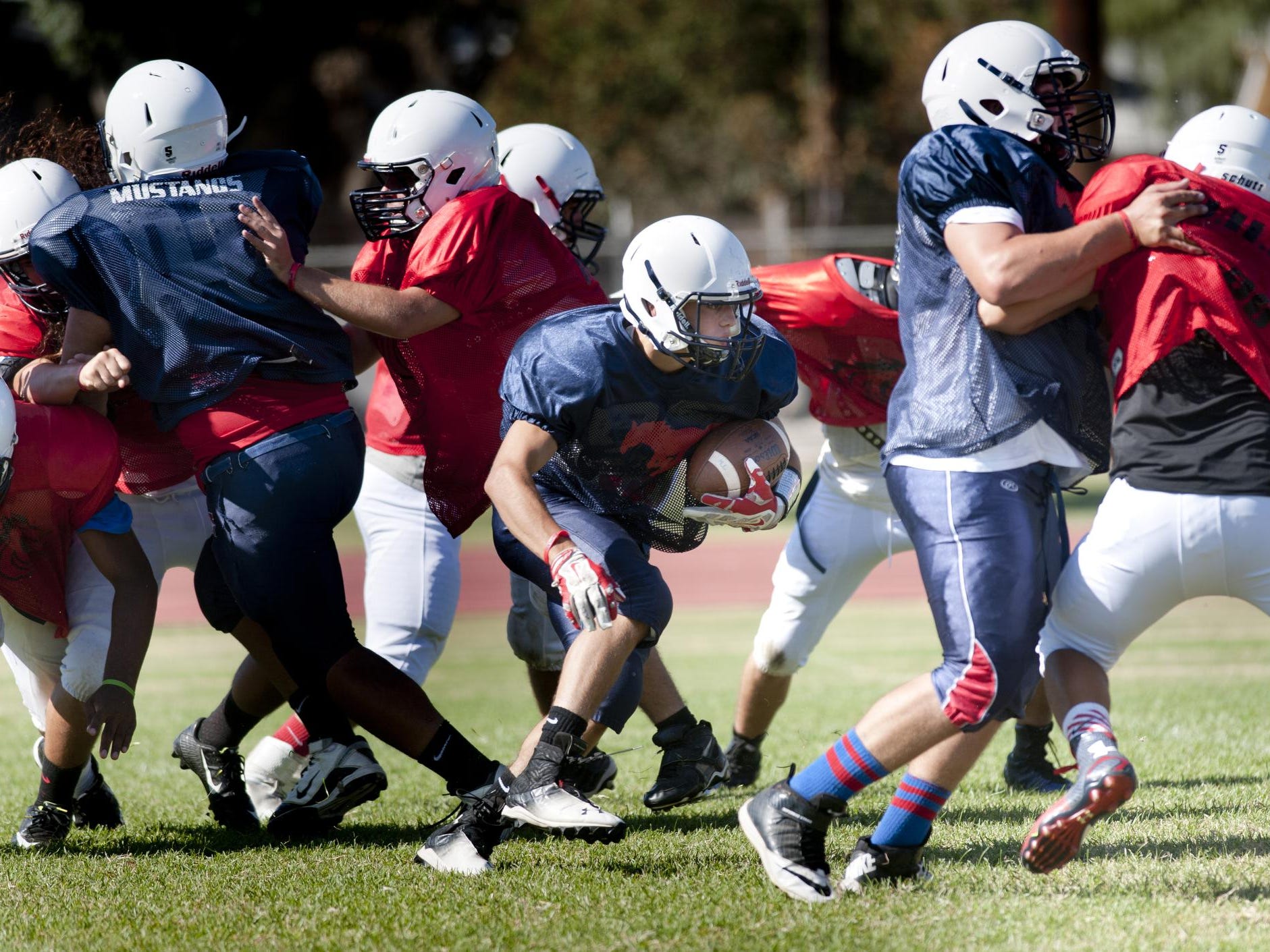 Tulare Western sophomore running back David Alcantar looks for room to run during an Aug. 11 practice at Tulare Western.