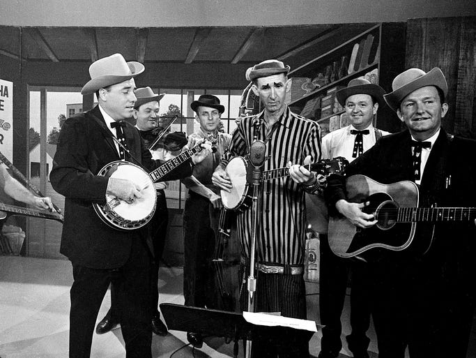 David "Stringbean" Akeman, striped shirt, performs with Lester Flatt and Earl Scruggs during a taping of the "Lester Flatt and Earl Scruggs Show" on Sept. 11, 1963.
