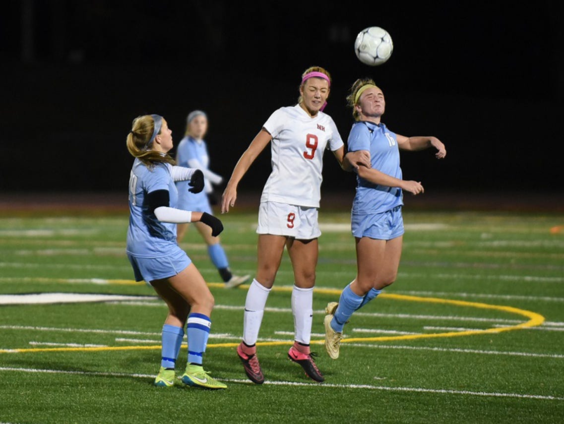 Northern Highlands Casey Richards (9) and WMC’s Madison Muscatella duel for the ball. Photo by Warren Westura for the Daily Record. November 17, 2015