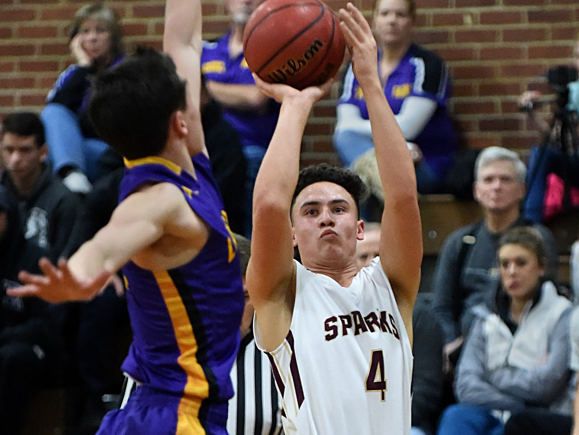 Sparks's James Bates shoots with Lassen's Kevin Barnetche looking to block during Tuesday's game at Sparks.