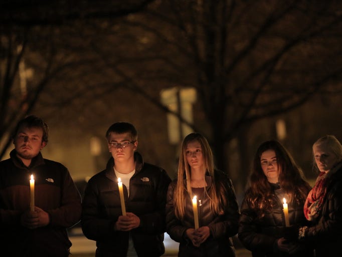 Mourners gather at a candlelight vigil on Tuesday,