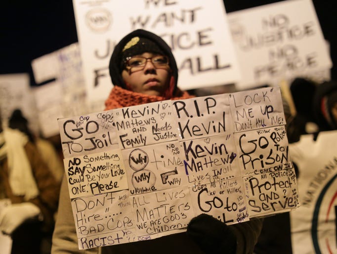 A protestor holds a sign while marching with civil