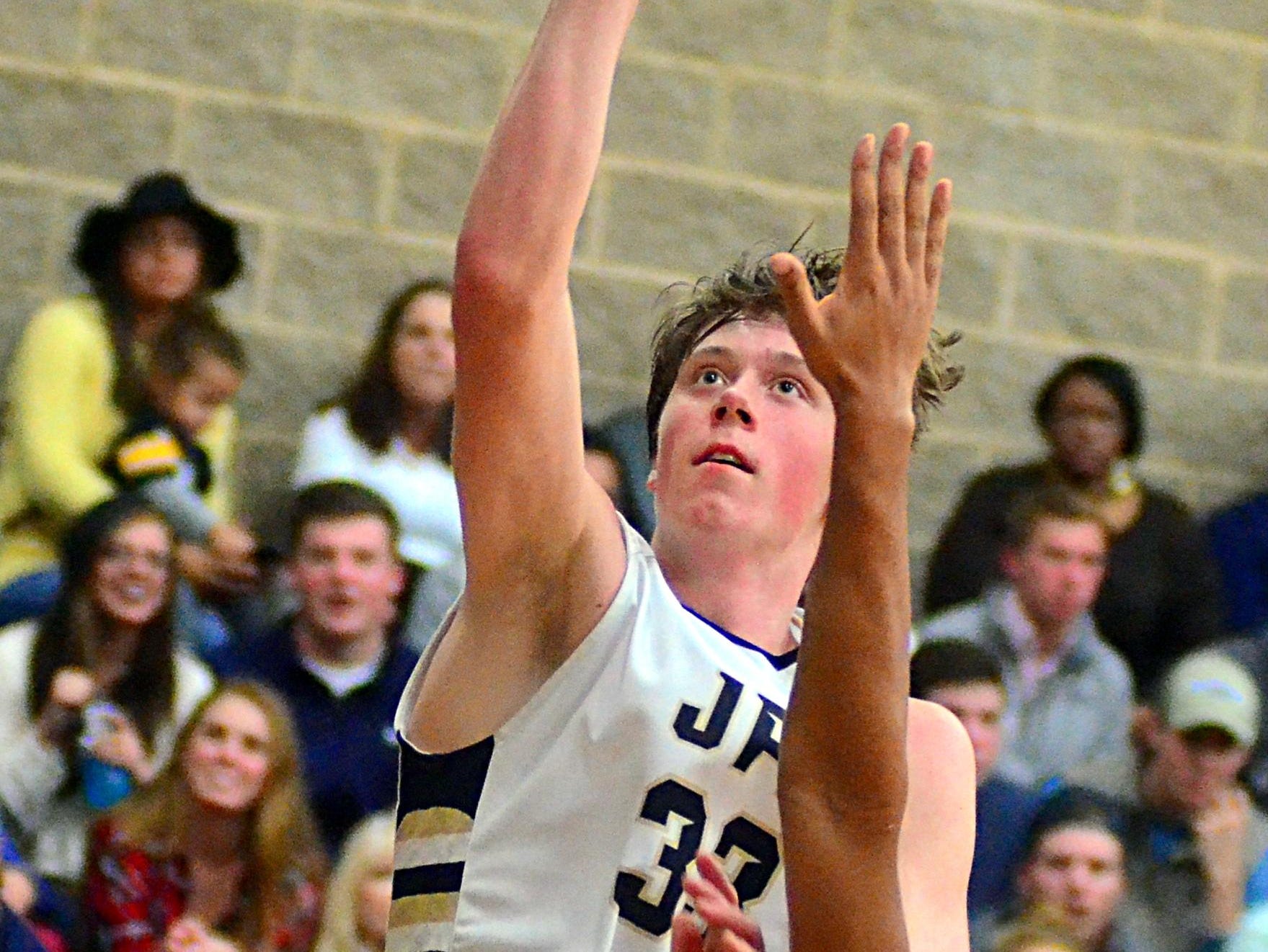 Pope John Paul II High junior forward Matt Galvin elevates for a layin over Father Ryan sophomore J.C. Clausi during third-quarter action.