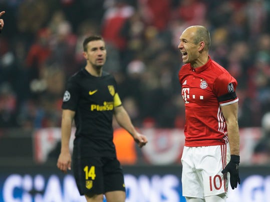 Bayern's Arjen Robben, right, reacts in direction of referee Clement Turpin during the Champions League Group D soccer match between FC Bayern Munich and Atletico Madrid in Munich, Germany, Tuesday, Dec. 6, 2016. In background Atletico's Gabi. (AP Photo/Matthias Schrader)