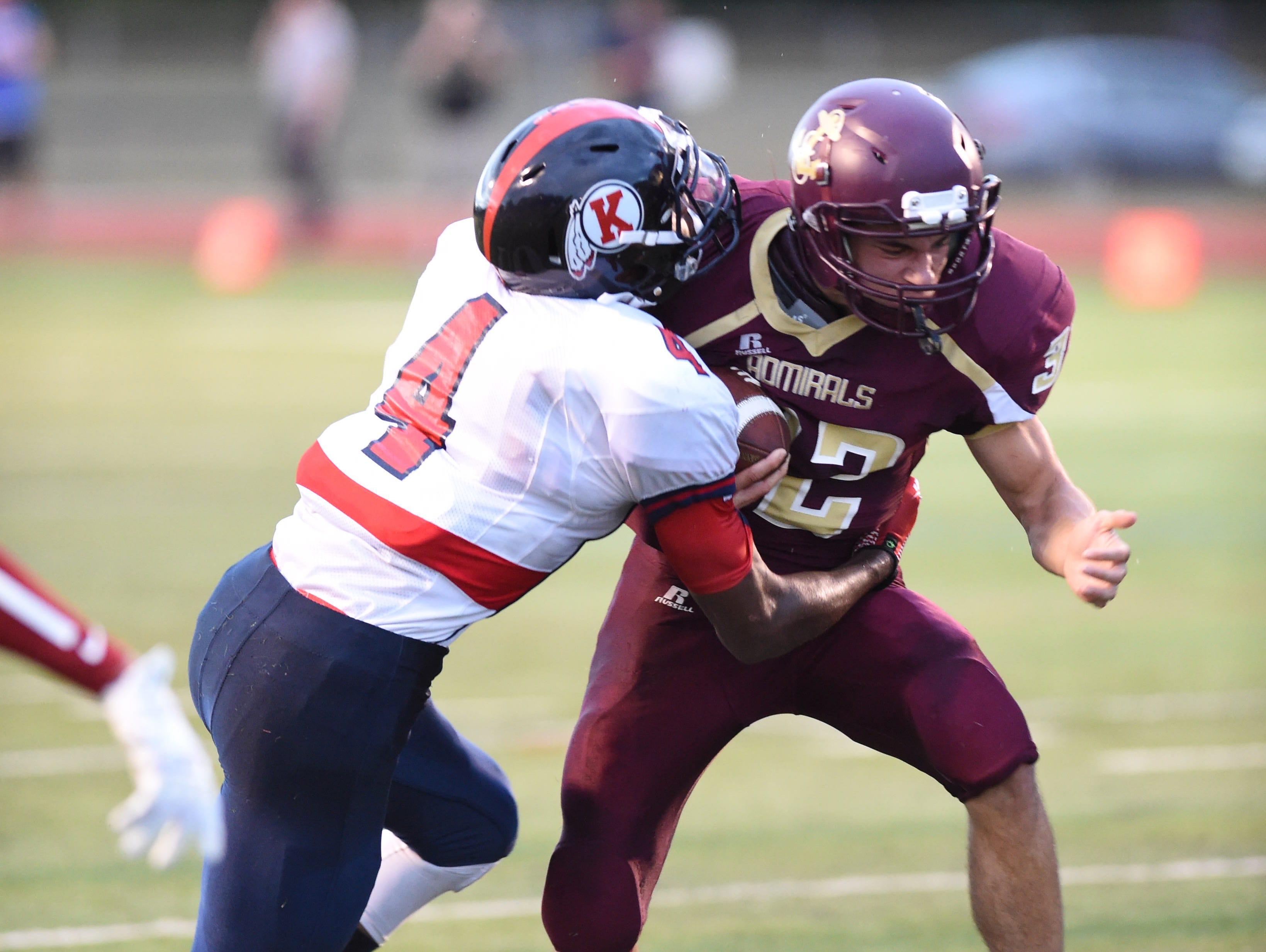 Ketcham's Jyaire Stevens tackles Arlington's EJ Escoto during Friday's game at Arlington High School.