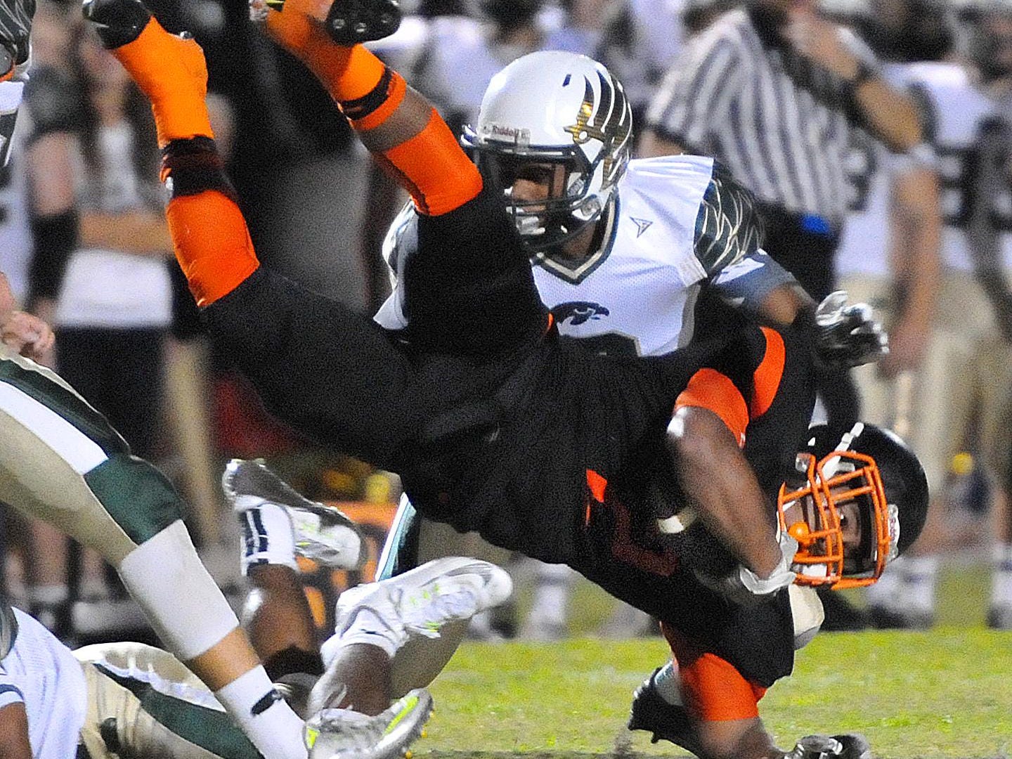 Cocoa High’s Timmy Pratt is up-ended by a host of Viera High defenders during Friday night’s game at Tiger Stadium.