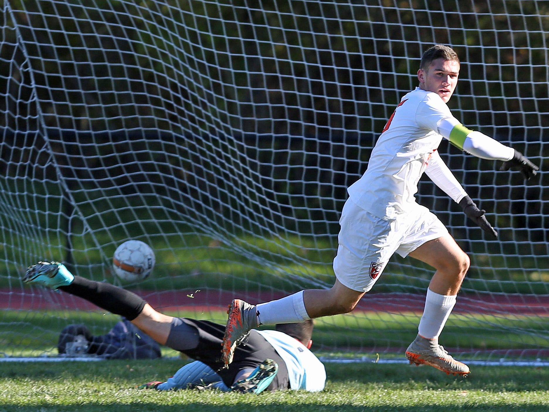 Greeley's Matt Neuberger (15) gets a shot pass North Rockland goal keeper Julio Rebolledo for his first of three goals in the first half during a boys soccer playoff game at Horace Greeley High School in Chappaqua Oct. 23, 2015.