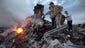 People inspect the crash site of a passenger plane near the village of Grabovo. Both the government and the pro-Russia separatists fighting in the region denied any responsibility for downing the plane.