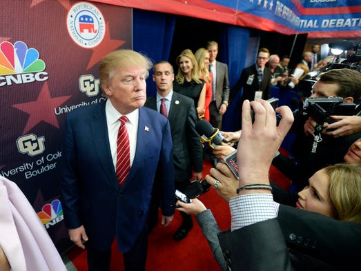 Trump is questioned by the media after the CNBC Republican