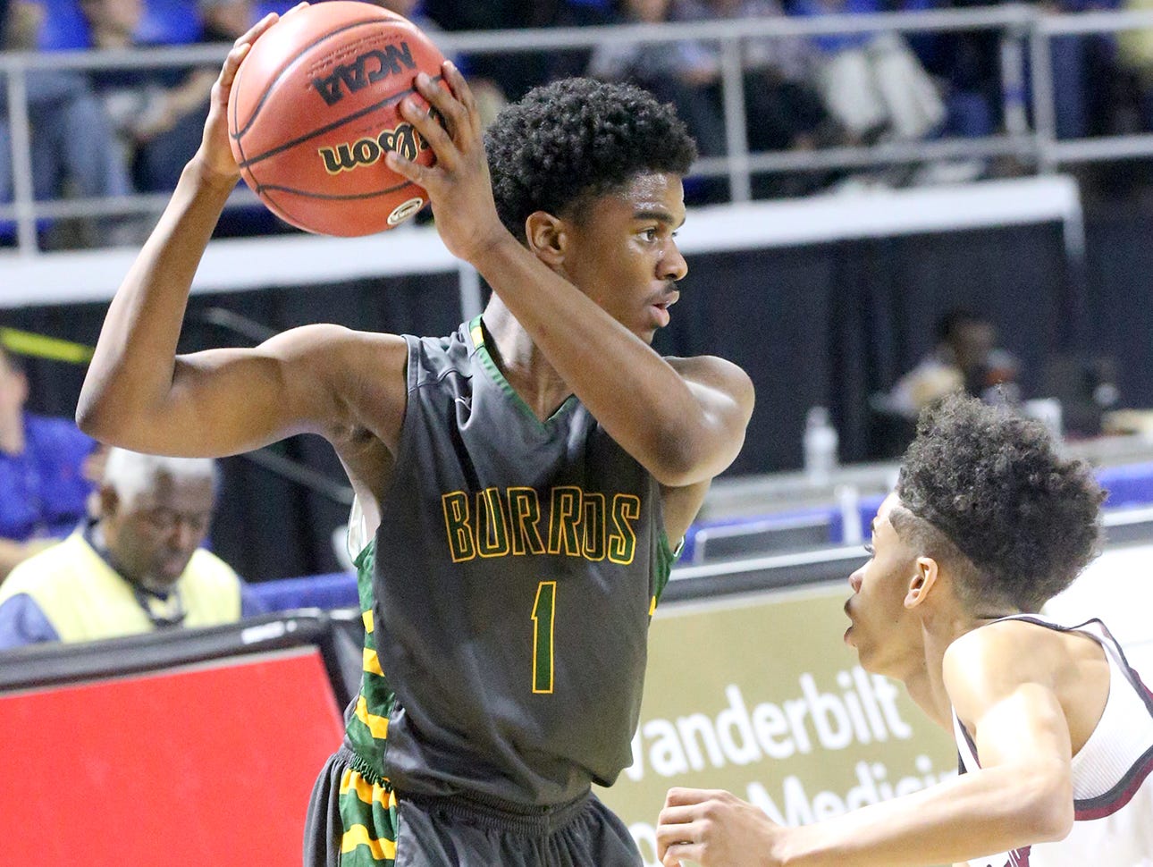 Hillsboro's Darius Ferguson (1) looks for an open player as he iis guarded by Memphis East's Nikcolauz Merriweather (0) during the State Tournament Quarterfinal game , on Wednesday at MTSU.