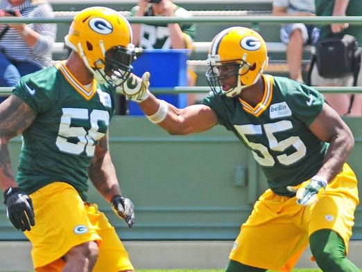 Green Bay Packers linebacker Andy Mulumba, right works against linebacker/defensive end Julius Peppers during minicamp practice at Ray Nitschke Field, Tuesday, June 17, 2014. H. Marc Larson/Press-Gazette Media