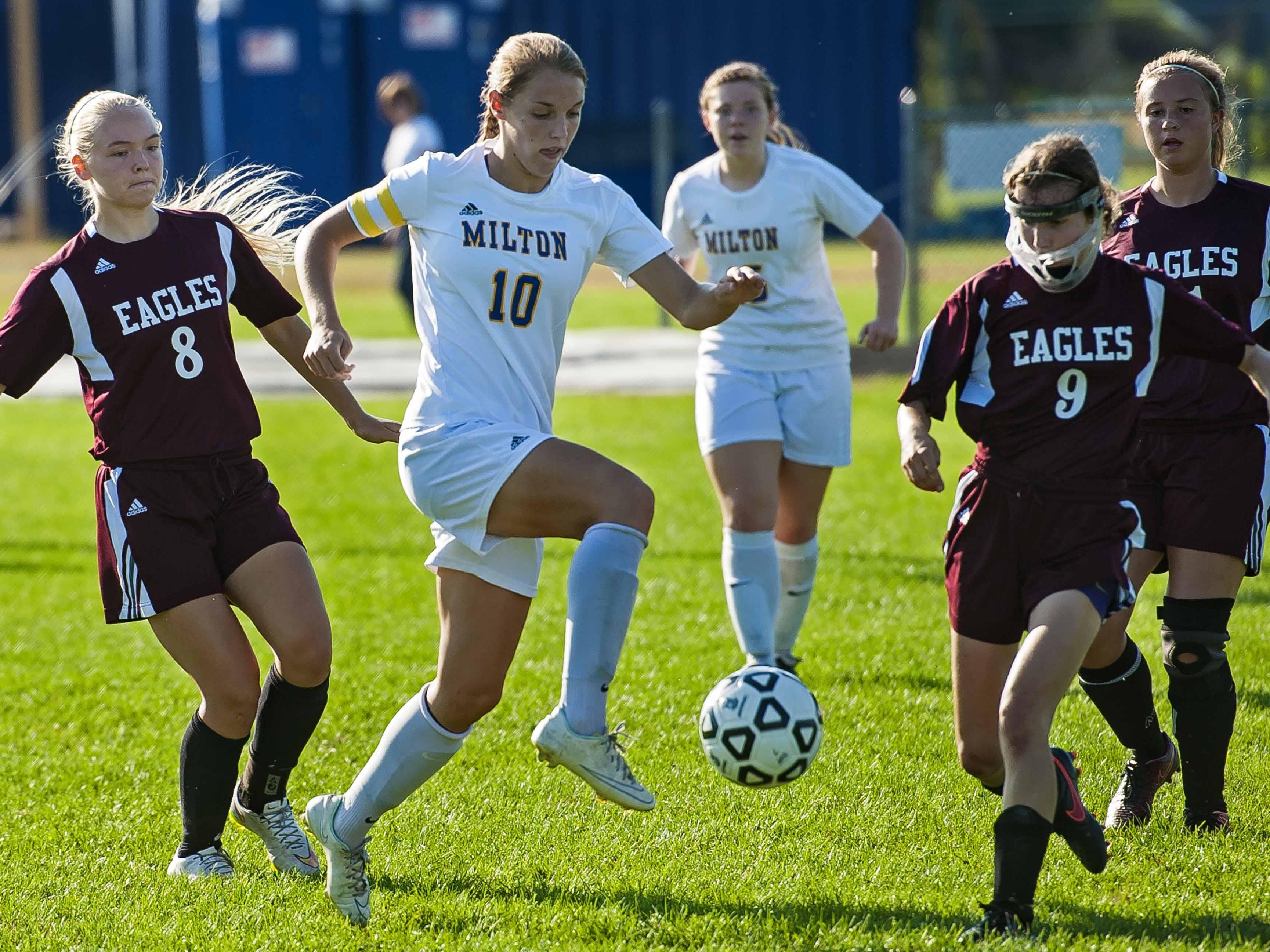 Milton's Caitlyn Dabagian, center, dribbles against Mount Abraham's Ernesta Mcintosh, left, and Hannah Funk in Milton on Wednesday.