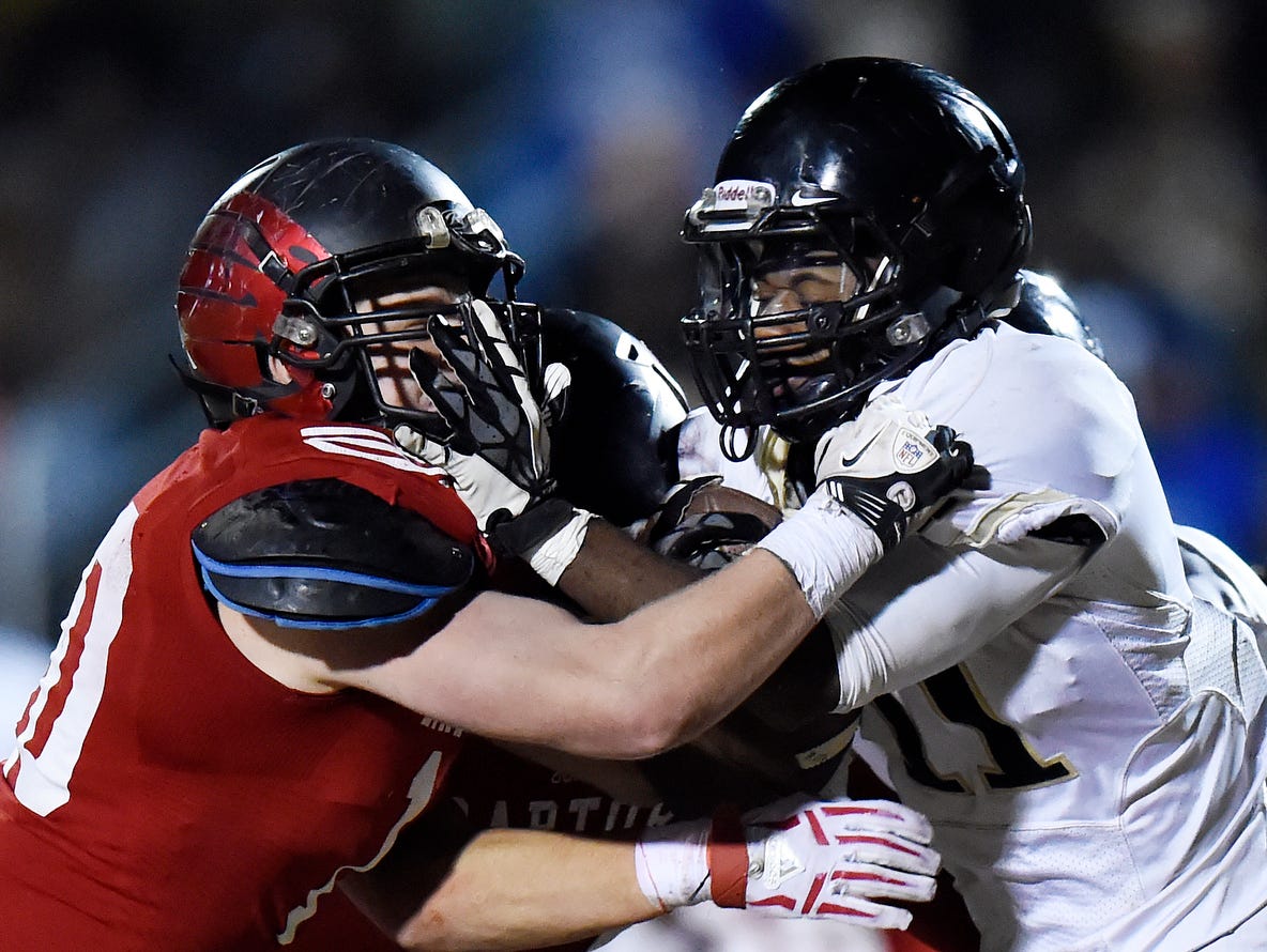 Ravenwood linebacker Angus Spence (10) stops Whitehaven running back Kylan Watkins (11) during the second half of an 6A semifinal playoff football game at Ravenwood High School on Friday, Nov. 27, 2015 in Brentwood, Tenn. Ravenwood won 20-13.