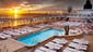 Crisp white deck furniture and inviting sunbeds accented with citrus-hued cushions and throw pillows are to be found on the Crystal Symphony's pool deck.