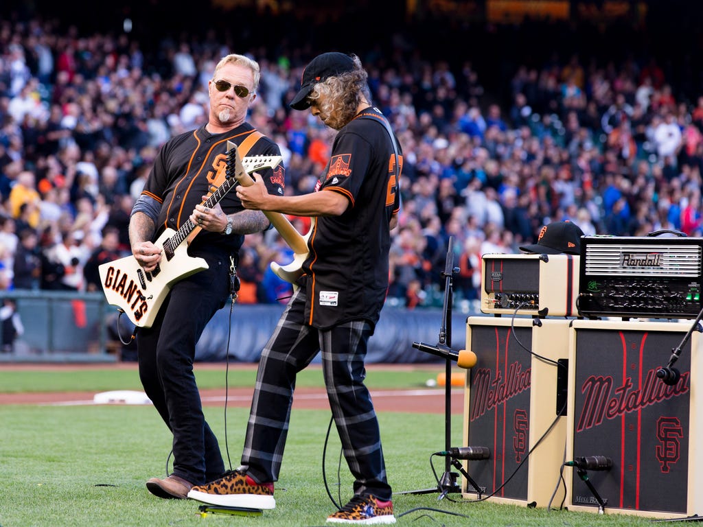 James Hetfield (left) and Kirk Hammett of the band Metallica perform the national anthem before the game between the San Francisco Giants and the Chicago Cubs at AT&T Park.