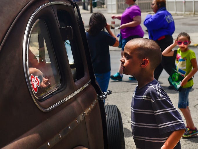 Eight-year-old Brayden Roberts peers into the window