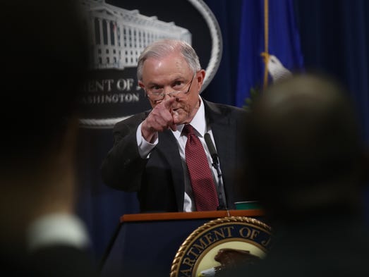 Sessions takes questions during a press conference