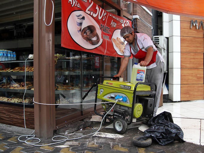 A man gets a generator working at a bakery in Ankara