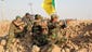 Members of the Iraqi Shiite militia Kataib Hezbollah take up a position during fighting near Amerli.