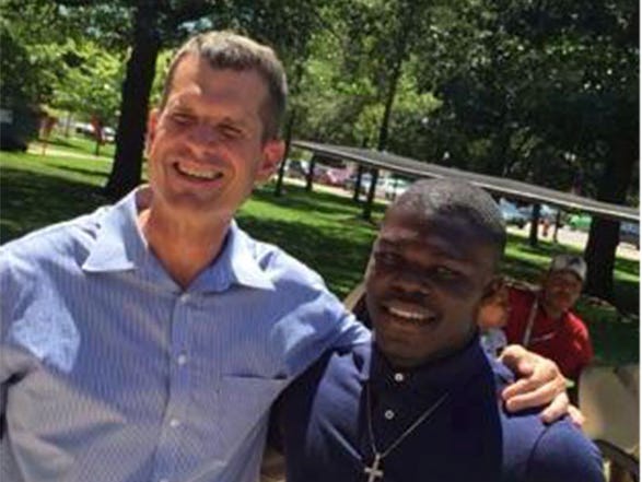 Michigan coach Jim Harbaugh and Covington (Ga.) Newton running back Kurt Taylor.