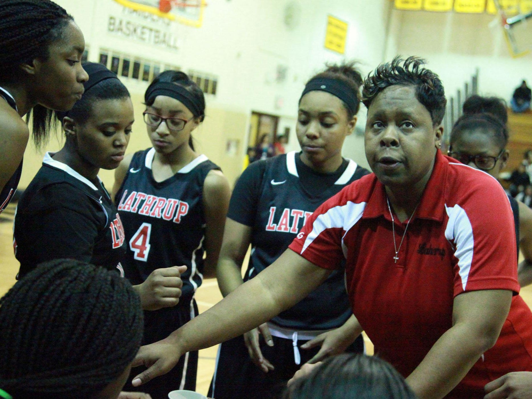 Lathrup coach Michele Marshall has words of advice for her players during a timeout.