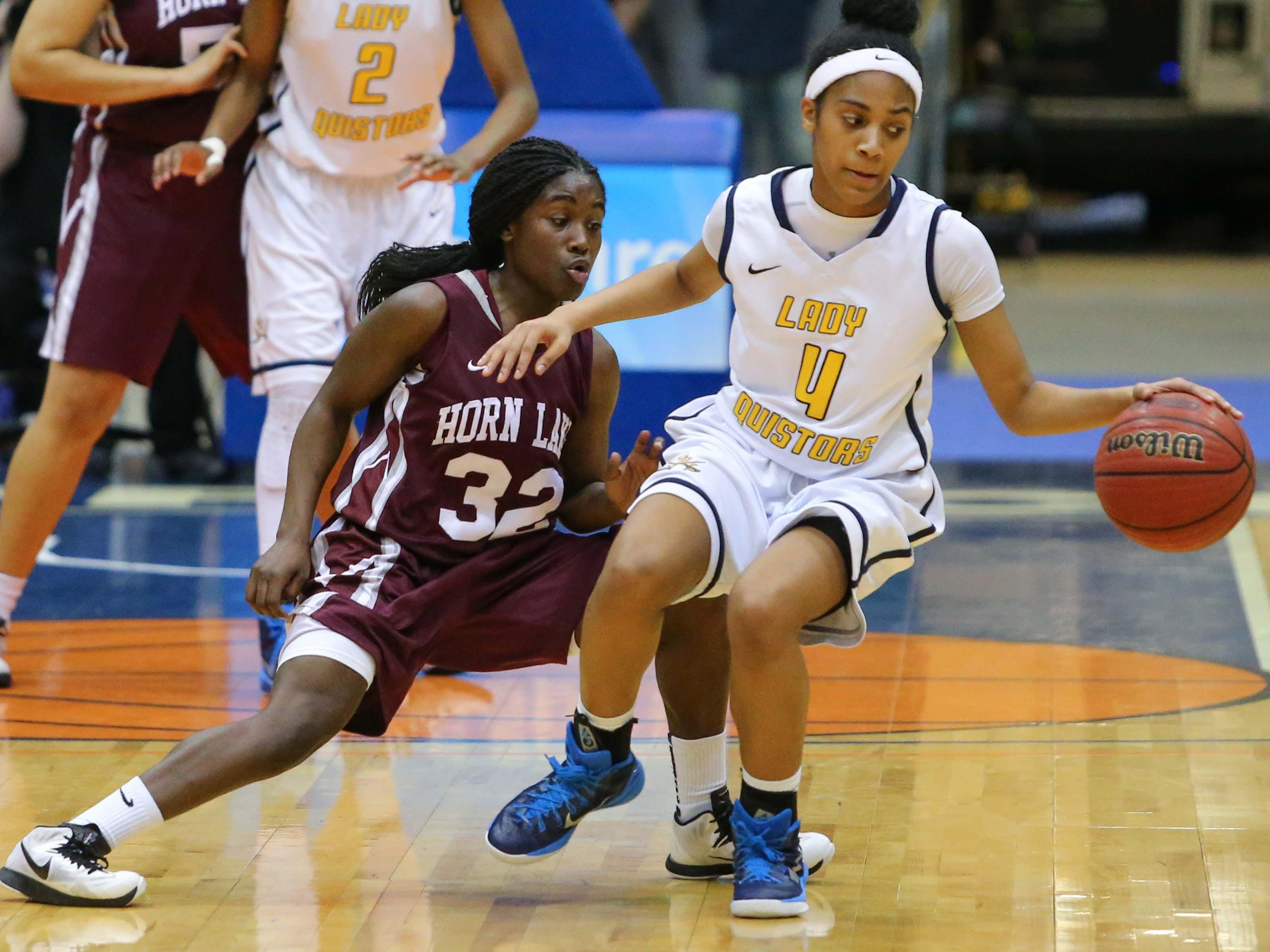 Olive Branch's Mahogany Vaught (4) controls the ball as Horn Lake's Alondrea Rush guards closely in the MHSAA Girls State 6A Basketball Championship Finals held in Jackson at the Mississippi Coliseum. (Bob Smith-Special to the Clarion Ledger)