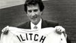 Mike Ilitch holds up his new uniform when he took the