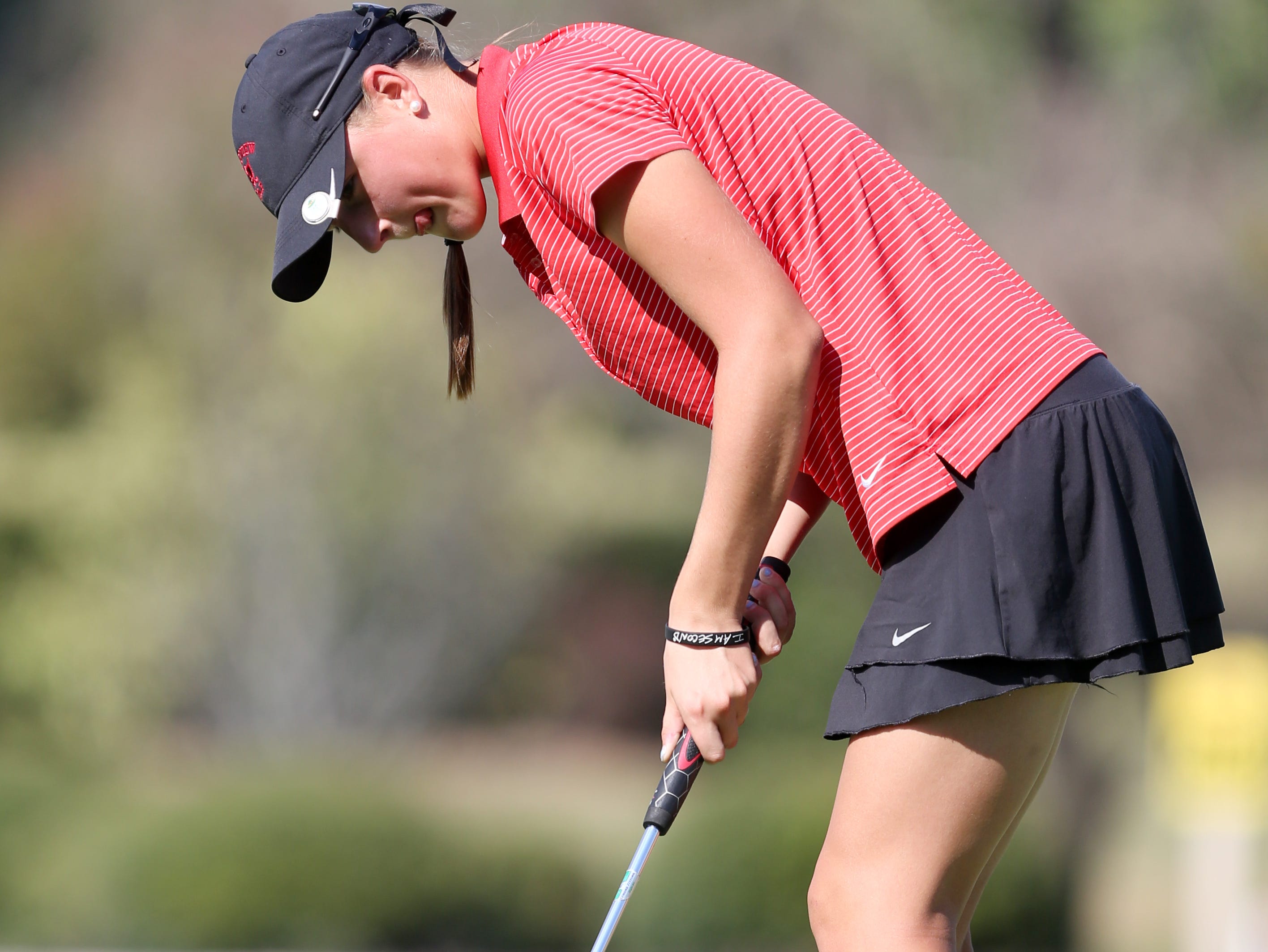 Reagan Greene of Rossview putts the ball into the hole Wednesday at the Class AAA State Golf Tournament at WillowBrook Golf Club in Manchester. Greene finished second overall.