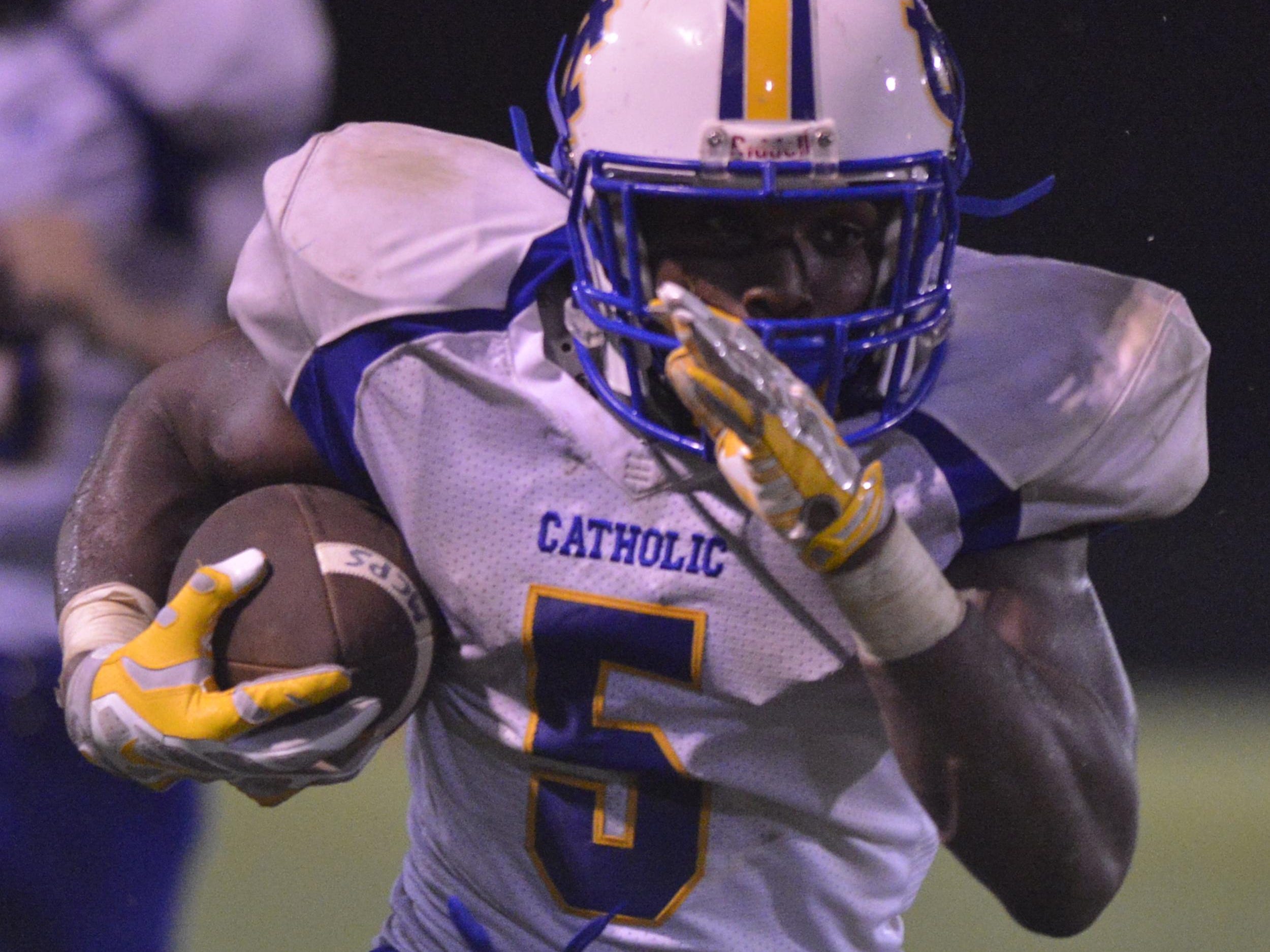 Catholic's Thomas Stokes (5) looks for running room during their game with Montgomery Academy on Friday, Aug. 22, 2014.