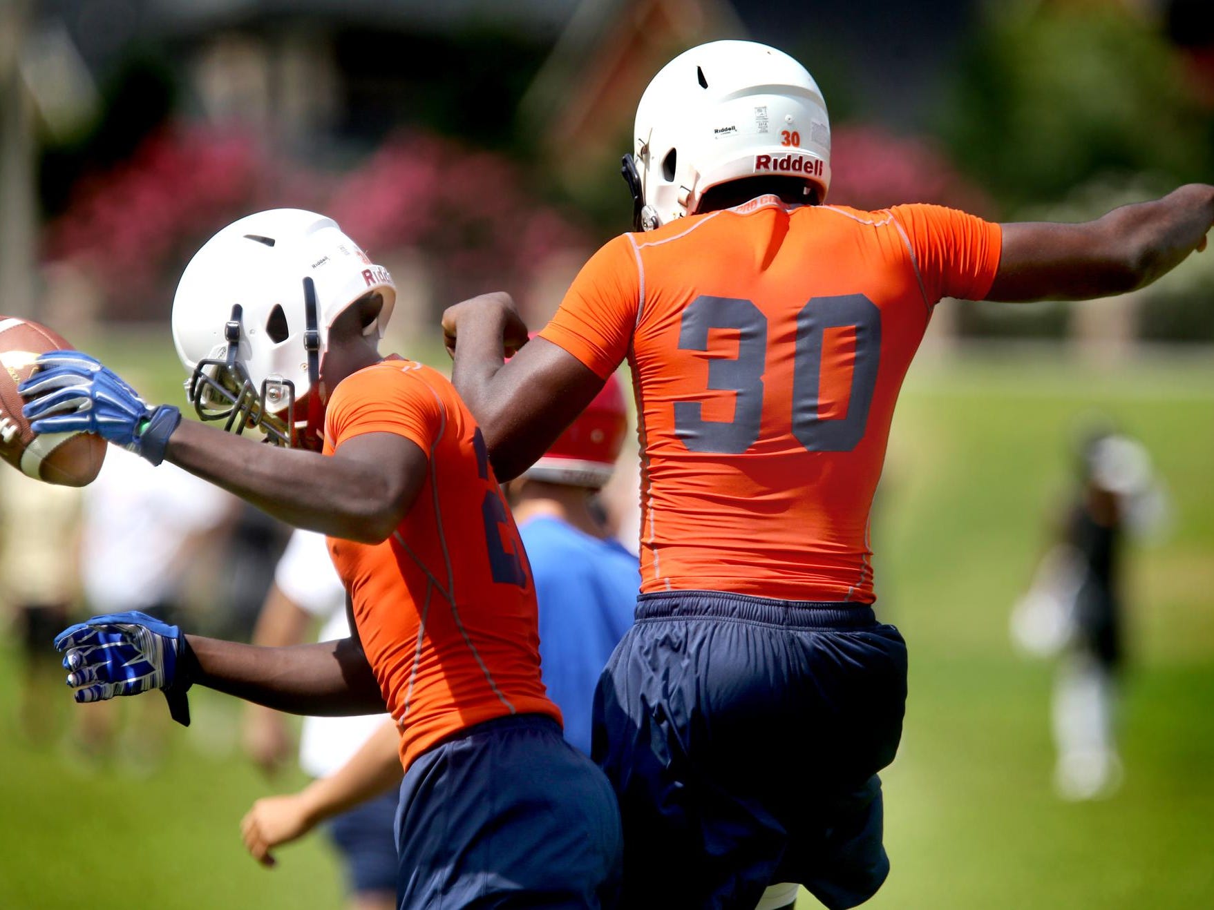 Blackman's Darius Simple and James Brown (30) celebrate a catch and run during Thursday’s Bojangles 7-on-7 Passing Tournament at Riverdale.