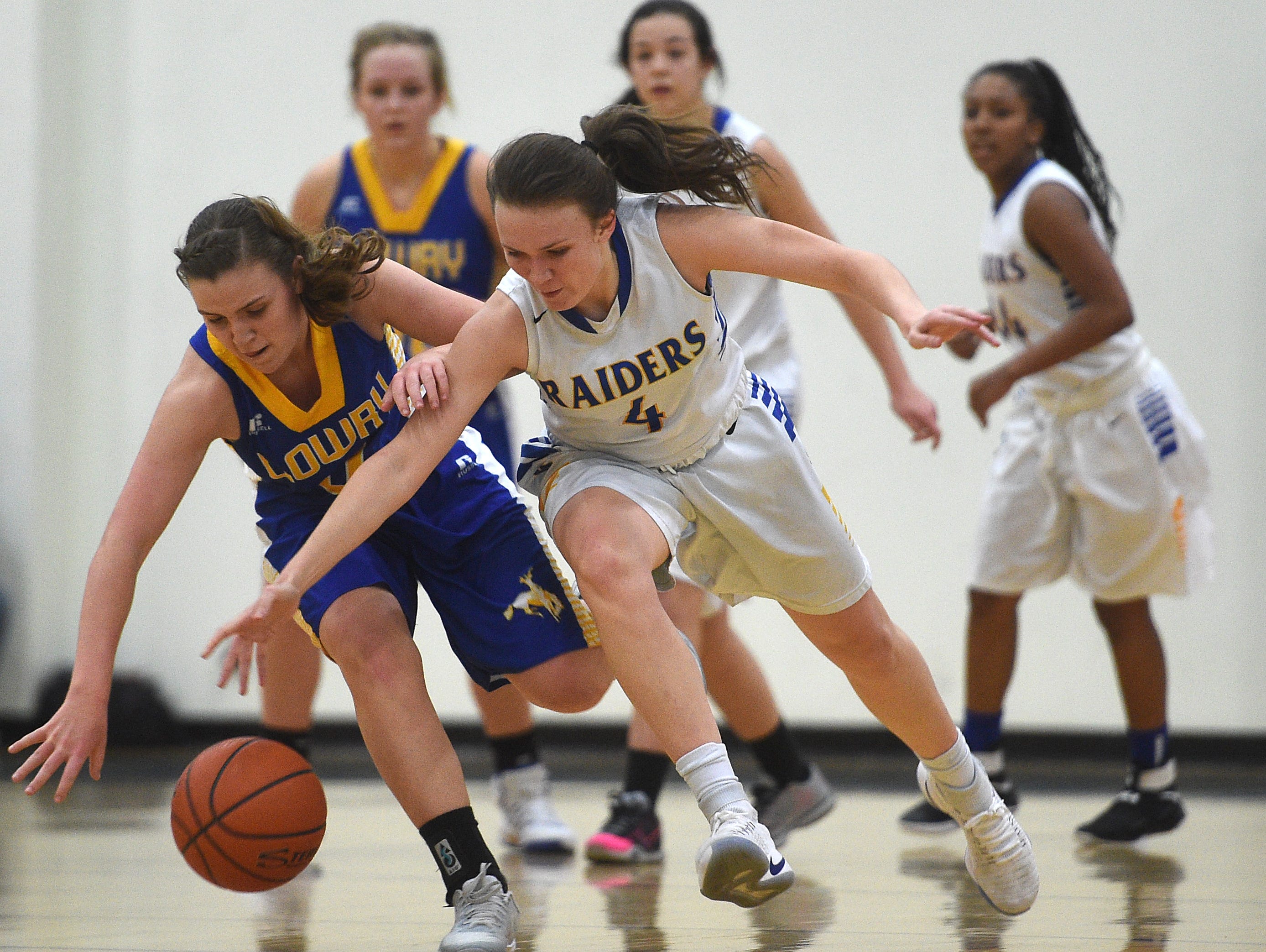 Reed's Taylor Johnson (4) battles Lowry's Sydney Connors for a loose ball during their basketball game Wednesday at McQueen.