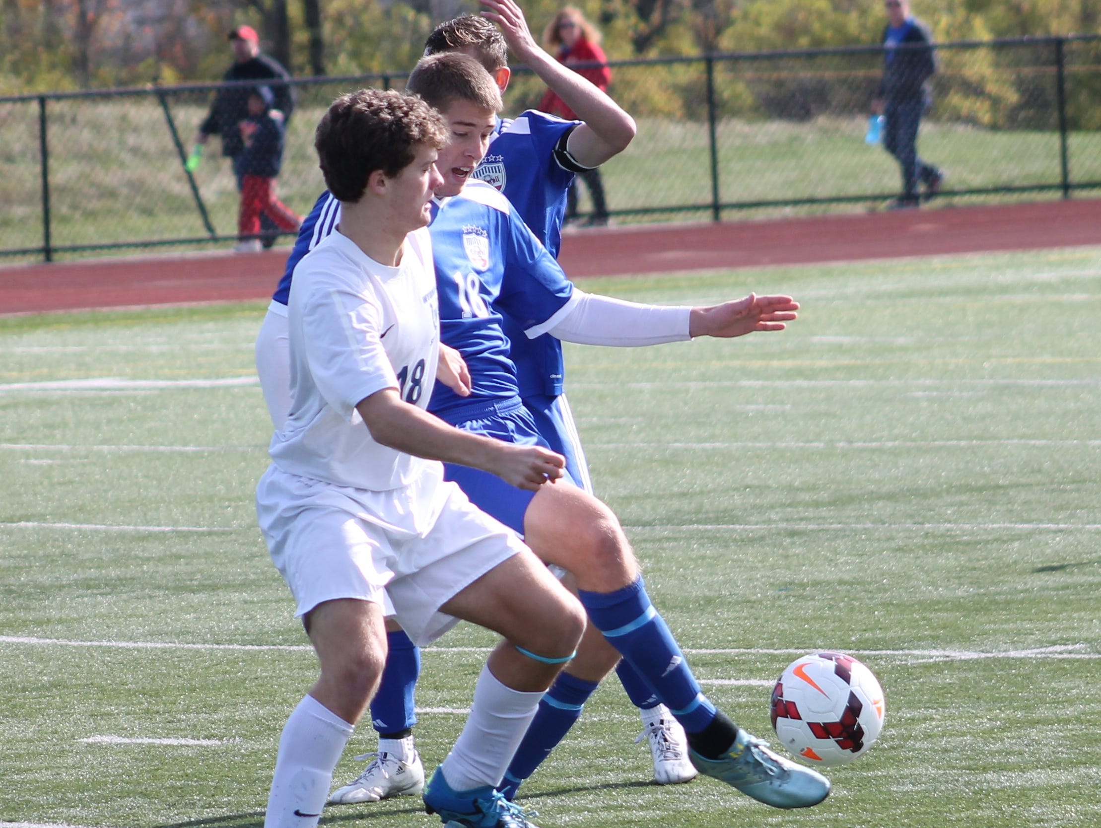 Junior Andrew Derge battles for the ball against Carroll Nov. 7 in the DII regional final