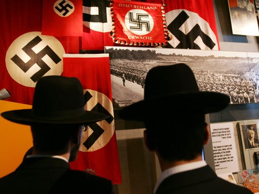 Ultra-Orthodox Jews look at an exhibit on Adolf Hitler
