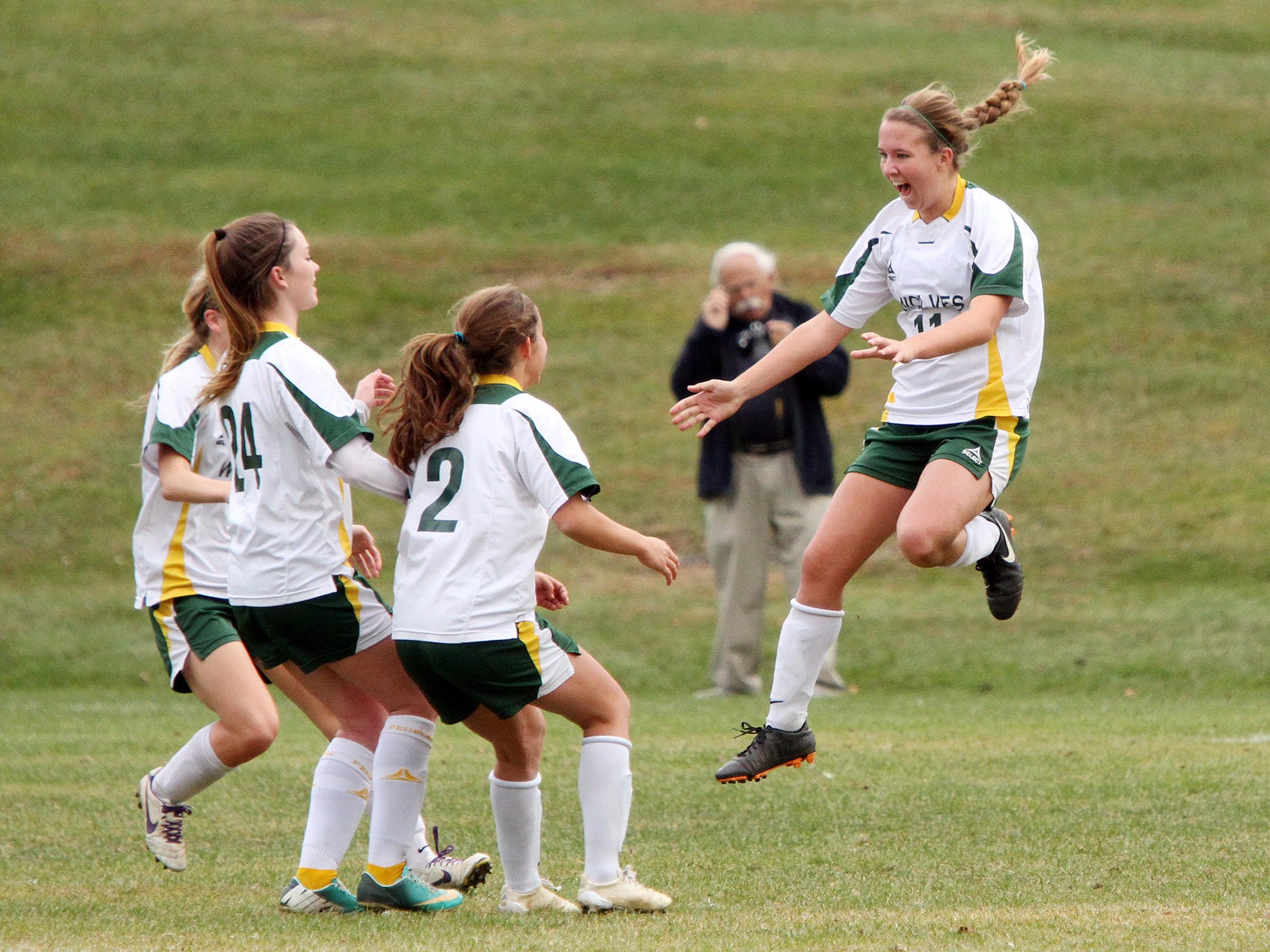 Peoples Academy's Katie Stames leaps in celebration after her penalty kick goal in the second half of the Wolves' 4-1 win over Thetford in the Division III girls soccer state championship game at Williamtown High School on Saturday.